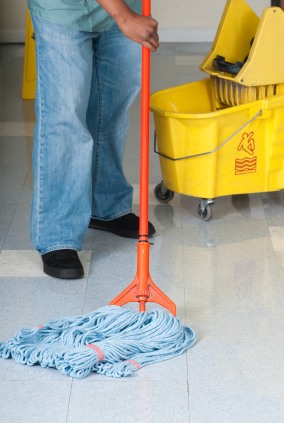 BlackHawk Janitorial Services LLC janitor in North Atlanta, GA mopping floor.